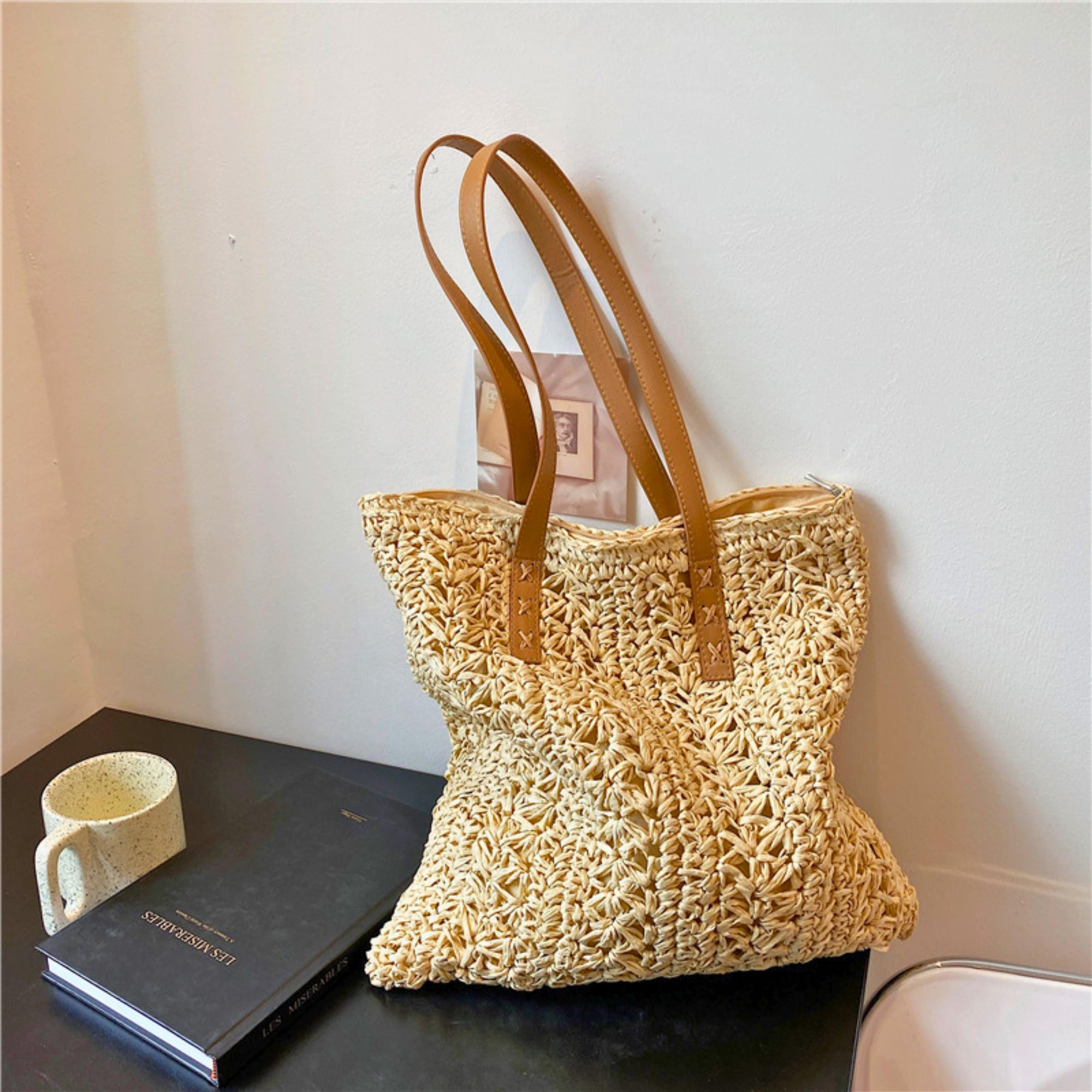 Woven straw tote bag in khaki and beige with a handwoven design, featuring a single shoulder strap and large interior capacity, ideal for beach days, summer outings, and daily casual use.