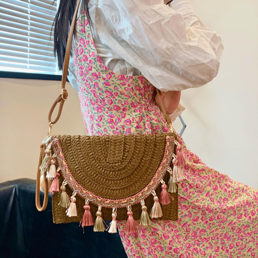 Beach vacation essentials – woven straw handbag with handmade tassel accents